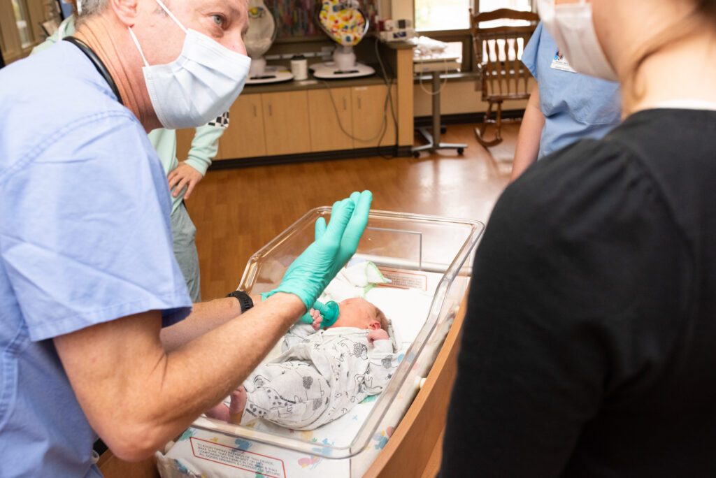 Dr. Perry Brown, Pediatrician, teaching a resident during their clinical rotations on care for an infant at St. Luke's Hospital in Boise, ID.